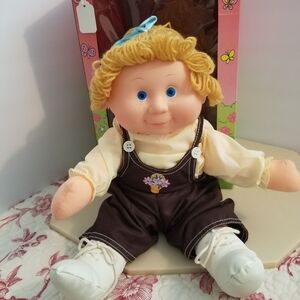 Adorable Plush Doll with Brown Overalls and Blue Eyes
